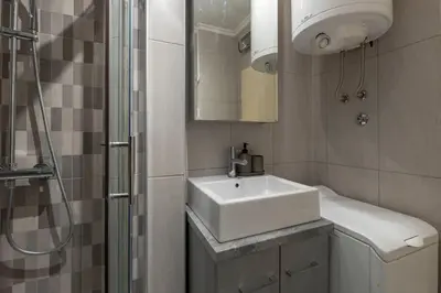 a bathroom with a white sink and a shower at Belgrade Center Apartment in Belgrade