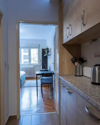 a kitchen with a table and a dining room at Belgrade Center Apartment in Belgrade