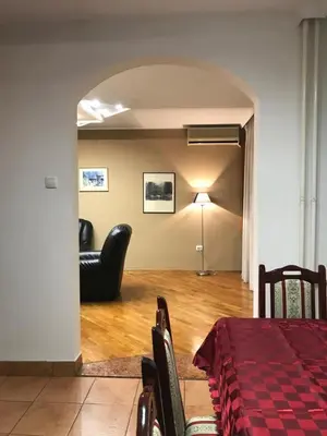a living room with a table and chairs and a couch at Bulevar NT Novi Beograd, Zemun in Belgrade