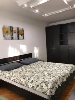 a bedroom with a bed with flowers on it at Bulevar NT Novi Beograd, Zemun in Belgrade
