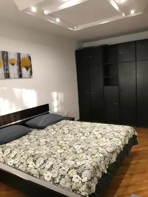 a bedroom with a bed with flowers on it at Bulevar NT Novi Beograd, Zemun in Belgrade