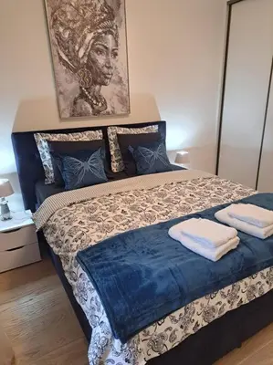 a bedroom with a bed with two towels on it at MarijaN Belgrade Waterfront in Sajmište