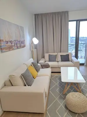 a living room with two white couches and a table at MarijaN Belgrade Waterfront in Sajmište