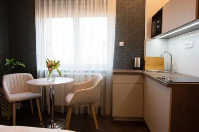 a kitchen with a table and chairs and a window at Square 6 in Belgrade