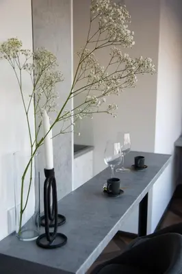 a table with a candle and a vase with flowers at Square 6 in Belgrade