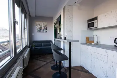 a kitchen with a bar and a chair in a room at Square 6 in Belgrade
