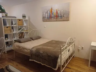 a bedroom with a bed and a painting on the wall at NMD Apartments in Zvezdara