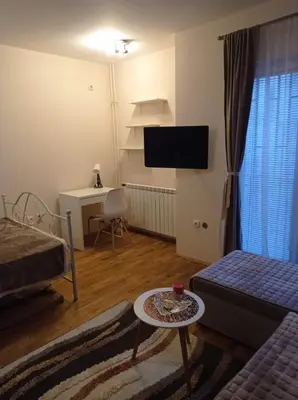 a living room with a bed and a couch and a table at NMD Apartments in Zvezdara
