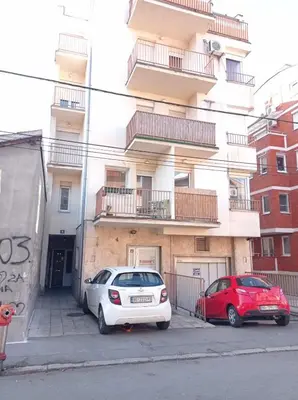 two cars parked in front of a building at NMD Apartments in Zvezdara