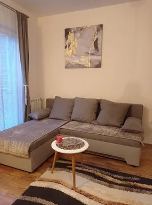 a living room with a couch and a table at NMD Apartments in Zvezdara