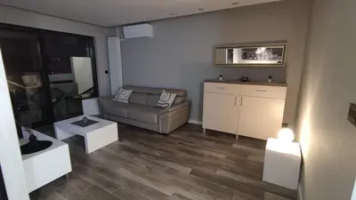 a living room with a couch and a table at Alisa Novi Beograd in Bežanija
