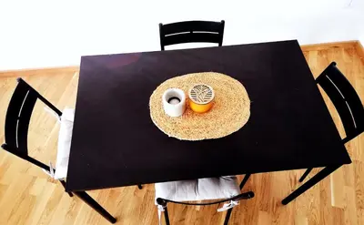 a black table with a cup of coffee on it at Apartman Kedar in Arandjelovac