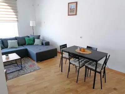 a living room with a table and a couch at Apartman Kedar in Arandjelovac