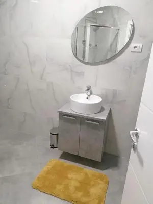 a bathroom with a sink and a mirror at Apartman Kedar in Arandjelovac