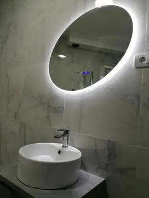 a bathroom with a white sink and a mirror at Apartman Kedar in Arandjelovac