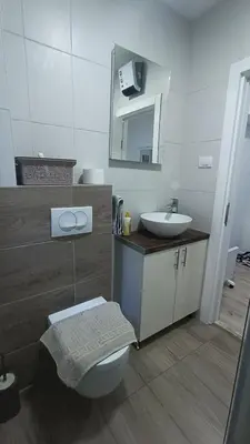 a bathroom with a sink and a toilet and a mirror at Gepratova Apartment in Belgrade