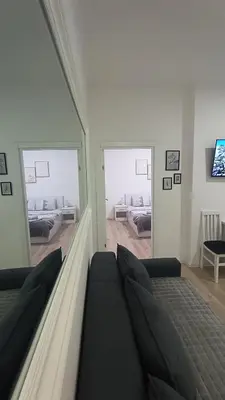 a bedroom with two beds and a large mirror at Gepratova Apartment in Belgrade