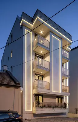 a building with balconies and a car parked in front at Star32 in Vračar (historical)