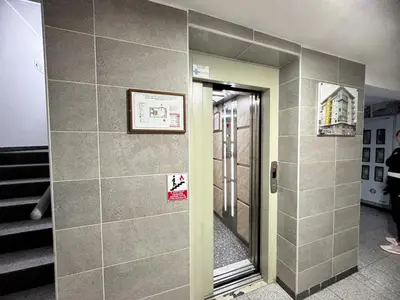 a mirror on a wall in a hallway at Most apartman in Ruma