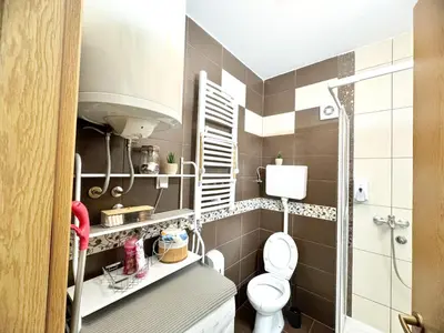 a small bathroom with a toilet and a sink at Most apartman in Ruma