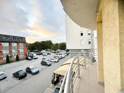 a view of a parking lot with cars parked at Most apartman in Ruma