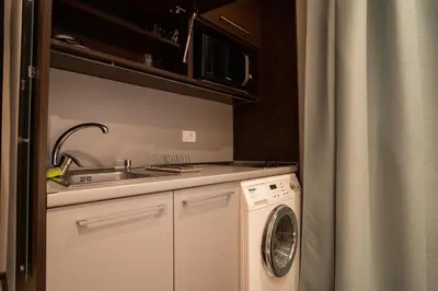 a kitchen with a sink and a washing machine at Cozy, Comfortable Apt Skadarlija in Belgrade