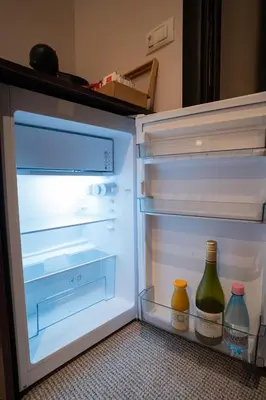 an open refrigerator with two bottles of wine in it at Cozy, Comfortable Apt Skadarlija in Belgrade