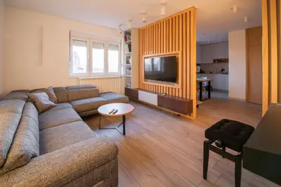 a living room with a couch and a tv in it at Roof terrace in the heart of Belgrade in Belgrade