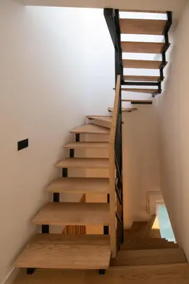 a stairwell in a house with wooden stairs and wooden floors at Roof terrace in the heart of Belgrade in Belgrade