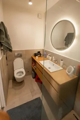 a bathroom with a toilet and a sink and a mirror at Roof terrace in the heart of Belgrade in Belgrade