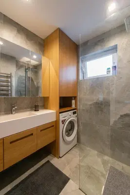 a bathroom with a washing machine and a sink at Roof terrace in the heart of Belgrade in Belgrade