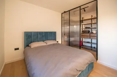 a bedroom with a large bed and a glass closet at Roof terrace in the heart of Belgrade in Belgrade