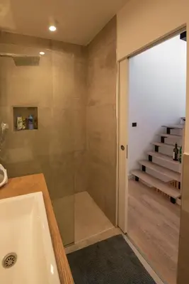 a bathroom with a tub and a shower and stairs at Roof terrace in the heart of Belgrade in Belgrade