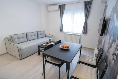 a living room with a table and a couch at Pegasus apartments in Belgrade