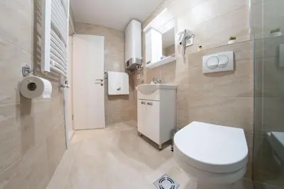 a bathroom with a white toilet and a sink at Pegasus apartments in Belgrade