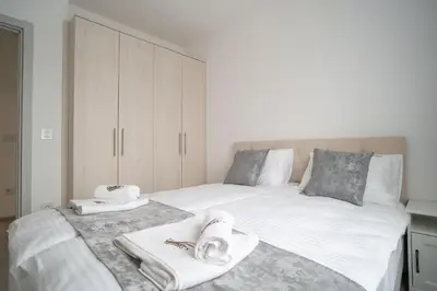 a bedroom with a large bed with towels on it at Pegasus apartments in Belgrade