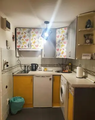 a kitchen with yellow and white cabinets and a dishwasher at Glorry M in Belgrade