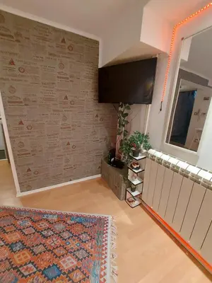 a living room with a wall with a tv at Glorry M in Belgrade