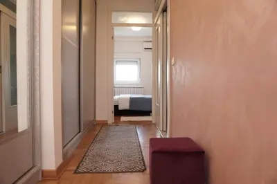 a hallway with a room with a bed and a rug at Dolce Vita Apartment in Belgrade
