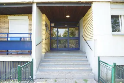a blue door on a house with stairs at Dolce Vita Apartment in Belgrade