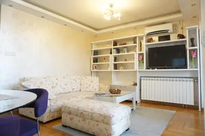 a living room with a couch and a tv at Dolce Vita Apartment in Belgrade