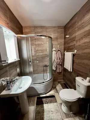 a bathroom with a shower and a toilet and a sink at Biser in Filmski Grad