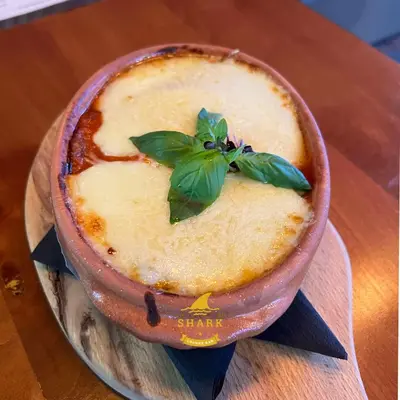 a bowl of food with a green leaf on top at Biser in Filmski Grad