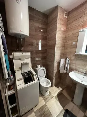 a small bathroom with a toilet and a sink at Biser in Filmski Grad