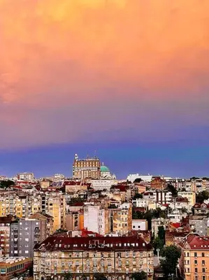 a city skyline with buildings and a cloudy sky at 2-Bedroom Oasis in the heart of the Waterfront in Sajmište