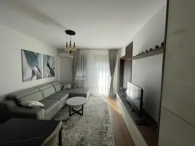 a living room with a couch and a table at Apartman M 21 in Karaburma