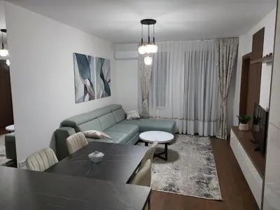 a living room with a couch and a table at Apartman M 21 in Karaburma