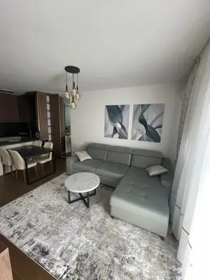 a living room with a couch and a table at Apartman M 21 in Karaburma