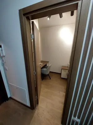 a hallway with a door open to a room with a toilet at Apartman M 21 in Karaburma