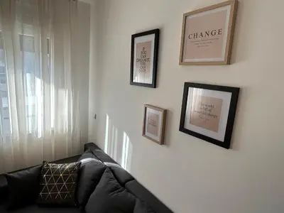 a living room with a couch and pictures on the wall at Delete 8 in Novi Grad